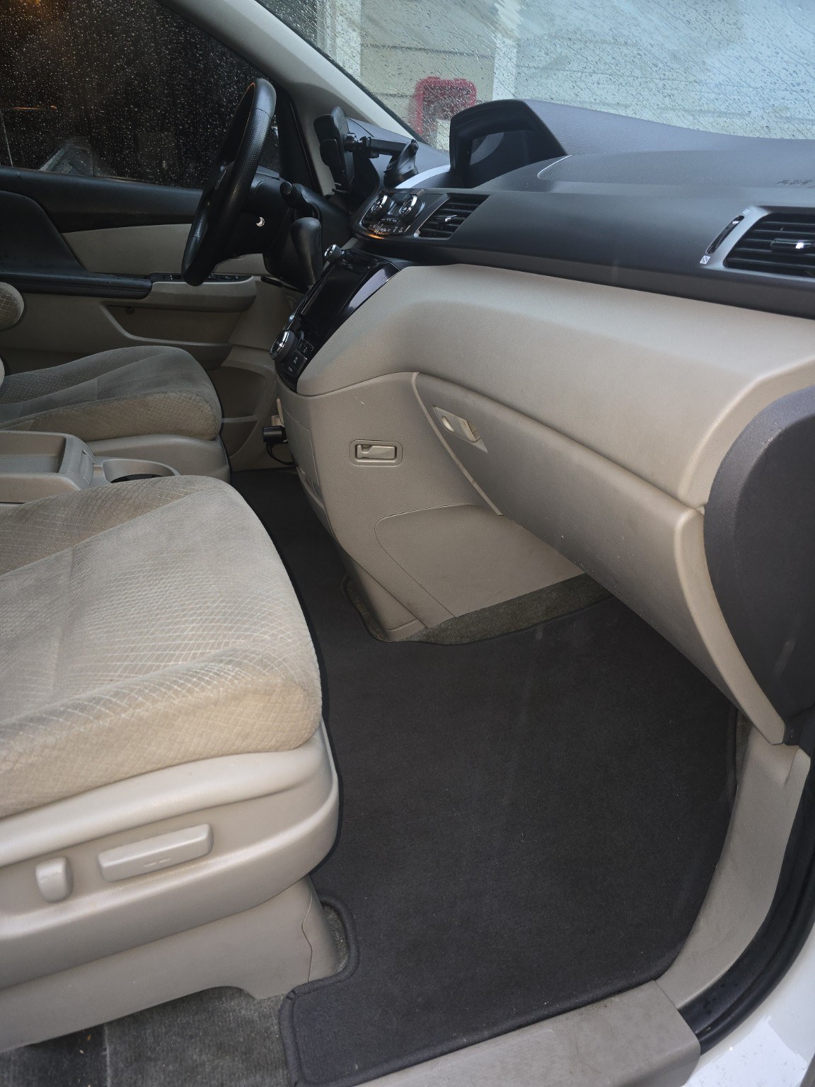 Clean front passenger floor area in a minivan